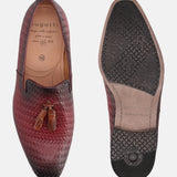 Red leather slip-on shoes by bugatti, featuring a woven texture and decorative tassels.
