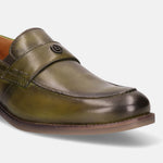 Green leather penny loafer by bugatti with a decorative metal logo on the upper strap.
