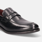 A black Men's bugatti Penny Loafer featuring a round apron toe, moulded  heel. Made from premium genuine leather with a durable tr outsole, this slip-on design offers both style and comfort.