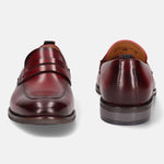 A grey Men's bugatti Penny Loafer featuring a round apron toe, moulded  heel. Made from premium genuine leather with a durable tr outsole, this slip-on design offers both style and comfort.