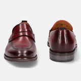 A grey Men's bugatti Penny Loafer featuring a round apron toe, moulded  heel. Made from premium genuine leather with a durable tr outsole, this slip-on design offers both style and comfort.
