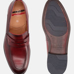 Red leather penny loafers by bugatti with visible logo and size markings, also showing the patterned sole.