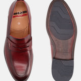 Red leather penny loafers by bugatti with visible logo and size markings, also showing the patterned sole.