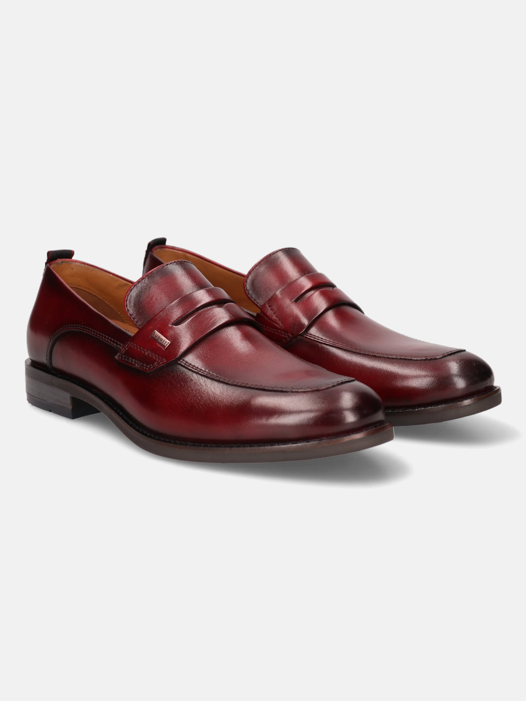 Red leather penny loafers by bugatti, featuring a smooth finish and classic styling.