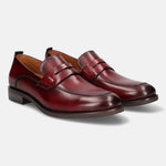 Red leather penny loafers by bugatti, featuring a smooth finish and classic styling.