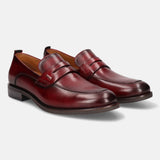 Red leather penny loafers by bugatti, featuring a smooth finish and classic styling.