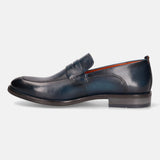 A blue Men's bugatti Penny Loafer featuring a round apron toe, moulded  heel. Made from premium genuine leather with a durable tr outsole, this slip-on design offers both style and comfort.