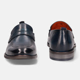 Blue leather penny loafers by bugatti with tonal stitching and visible orange lining.