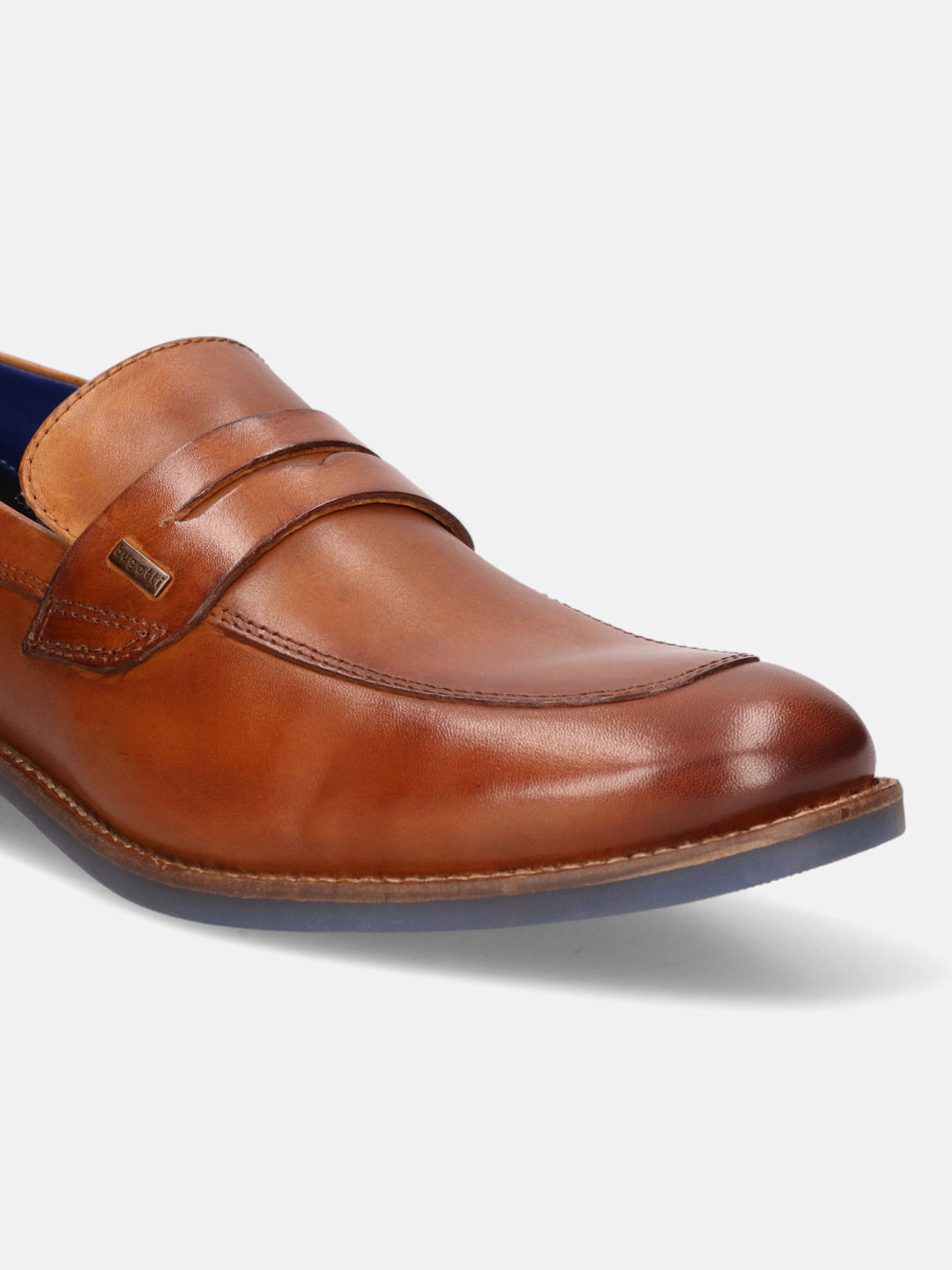 Cognac leather penny loafer by bugatti, featuring a tonal band and blue sole.