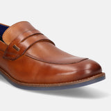 Cognac leather penny loafer by bugatti, featuring a tonal band and blue sole.