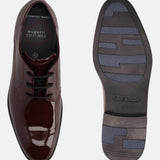 Burgundy leather derby dress shoes by bugatti, displaying the shoe's sole with geometric treads.