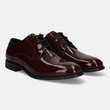 Bordeaux leather derby shoes by Bugatti featuring black laces and a shiny, patent finish.
