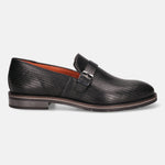 Black leather penny loafer by bugatti, featuring an all-over woven texture with a decorative buckle.
