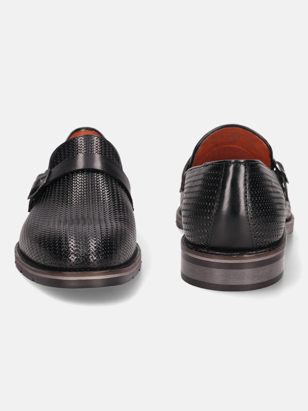 Black leather penny loafers by bugatti with decorative textured pattern and strap.
