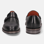 Black leather penny loafers by bugatti with decorative textured pattern and strap.