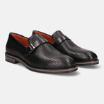 Black leather penny loafers by bugatti with a micro-perforated texture and an adjustable buckle.