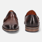 Brown leather penny loafers by bugatti with a textured, perforated pattern and a tonal strap.