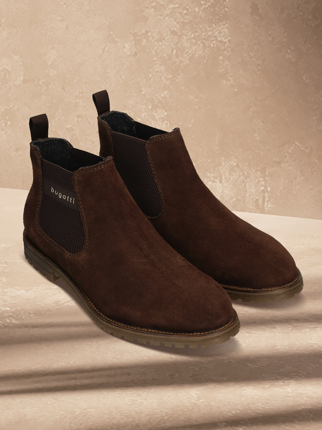 A brown Men's bugatti Chelsea Boots featuring a round toe plain toe, moulded  heel, and a wide fit. Made from premium genuine leather with a durable tr outsole, this elastic design offers both style and comfort.