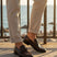 Bugatti Mansueto Bordo premium leather comfort slip-ons with a dark brown finish, styled with beige trousers.
