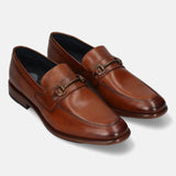 A cognac Men's bugatti Bit Loafer featuring a round toe apron toe, stacked heel. Made from premium genuine leather with a durable leather outsole, this slip-on design offers both style and comfort.