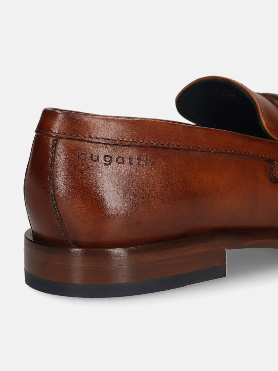 A cognac Men's bugatti Bit Loafer featuring a round toe apron toe, stacked heel. Made from premium genuine leather with a durable leather outsole, this slip-on design offers both style and comfort.