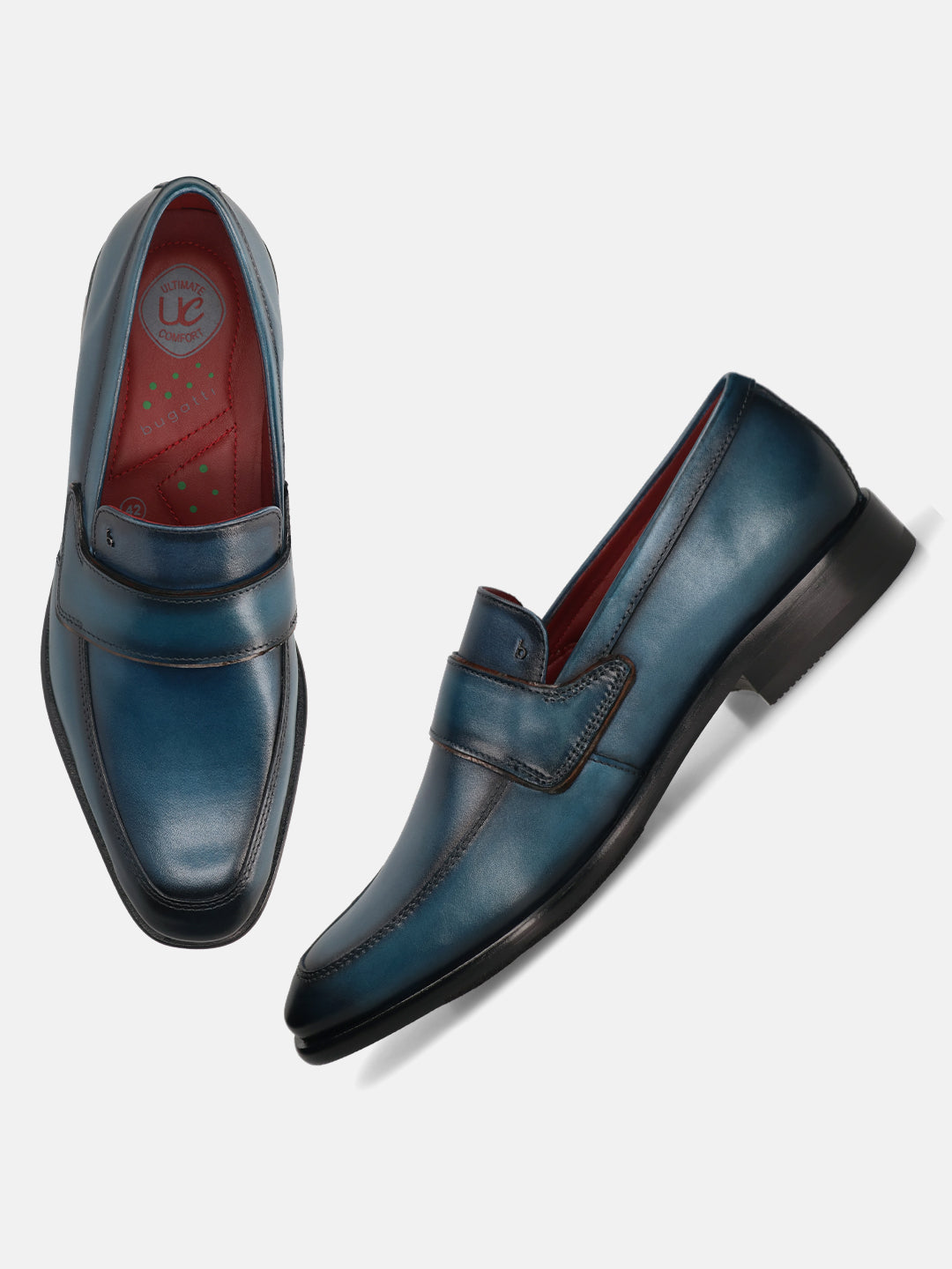 Dark blue leather slip-on formal shoes by bugatti, featuring a red insole and tonal stitching.
