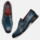 Dark blue leather slip-on formal shoes by bugatti, featuring a red insole and tonal stitching.
