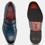 Dark blue leather slip-on shoe by bugatti, showing the top view and the sole of the shoe.