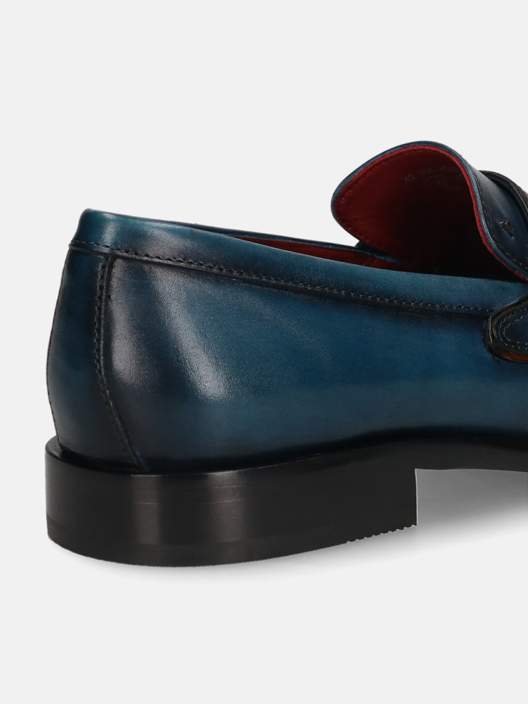 Dark blue leather loafer by bugatti with black soles, displayed in a back angle view.