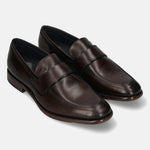 A brown Men's bugatti Penny Loafer featuring a round toe apron toe, stacked heel. Made from premium genuine leather with a durable leather outsole, this slip-on design offers both style and comfort.