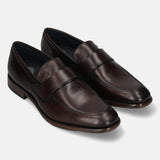 A brown Men's bugatti Penny Loafer featuring a round toe apron toe, stacked heel. Made from premium genuine leather with a durable leather outsole, this slip-on design offers both style and comfort.