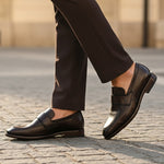 Bugatti Mansueto Flex Revo dark brown leather slip-on shoe, worn with dark brown dress pants.
