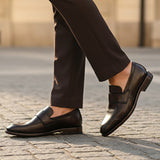 Bugatti Mansueto Flex Revo dark brown leather slip-on shoe, worn with dark brown dress pants.
