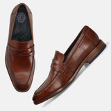 Cognac leather penny loafers by bugatti, with a woven leather strap detail and comfort insole.