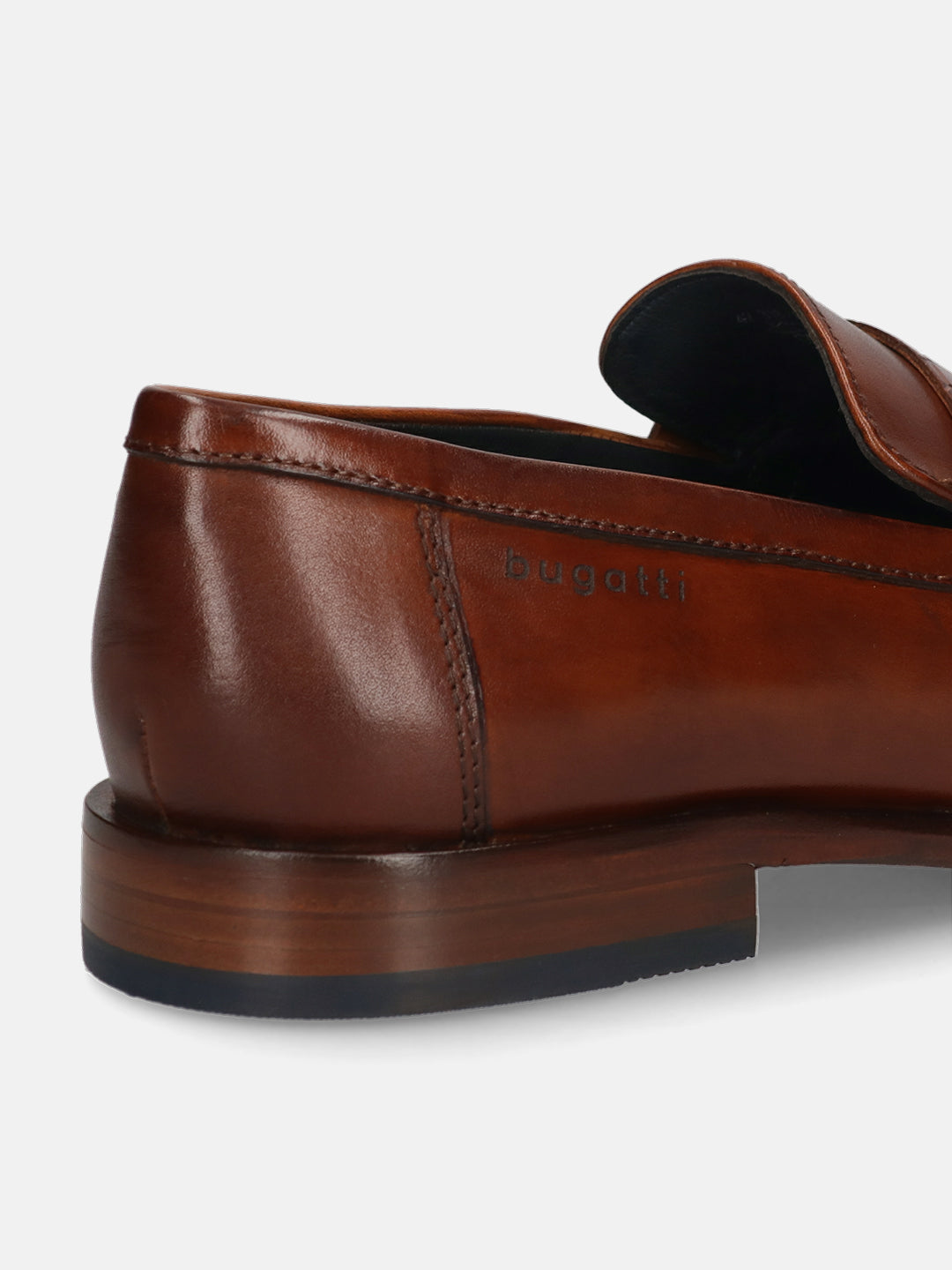 Cognac leather loafer by bugatti, featuring a smooth, polished finish, visible stitching, and a low heel.