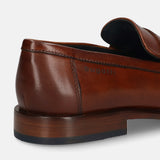 Cognac leather loafer by bugatti, featuring a smooth, polished finish, visible stitching, and a low heel.
