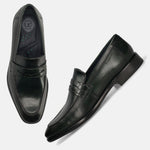 Dark green leather penny loafers by bugatti, featuring a braided leather strap detail, shown from above.
