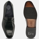 Dark green premium leather penny loafers by bugatti, showcasing croc-embossed details and the shoe's sole.