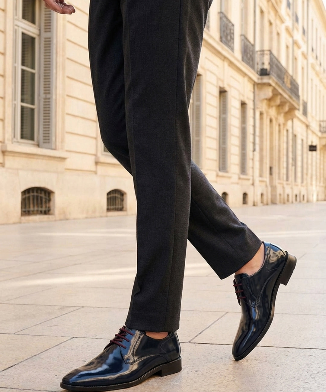 bugatti Lark flex dark blue leather derby shoes with brown laces, shown with gray trousers and a sidewalk.
