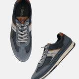 Bugatti Riptide blue comfort sneakers with suede and perforated texture, lace-up style, tan and gray accents.
