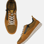 Yellow leather comfort sneakers by bugatti, with white laces and a tan sole.