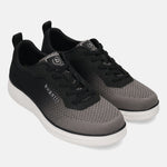 bugatti Astra Comfort Athleisure Sneakers in dark gray, featuring a mesh upper, lace-up closure, and white midsole.
