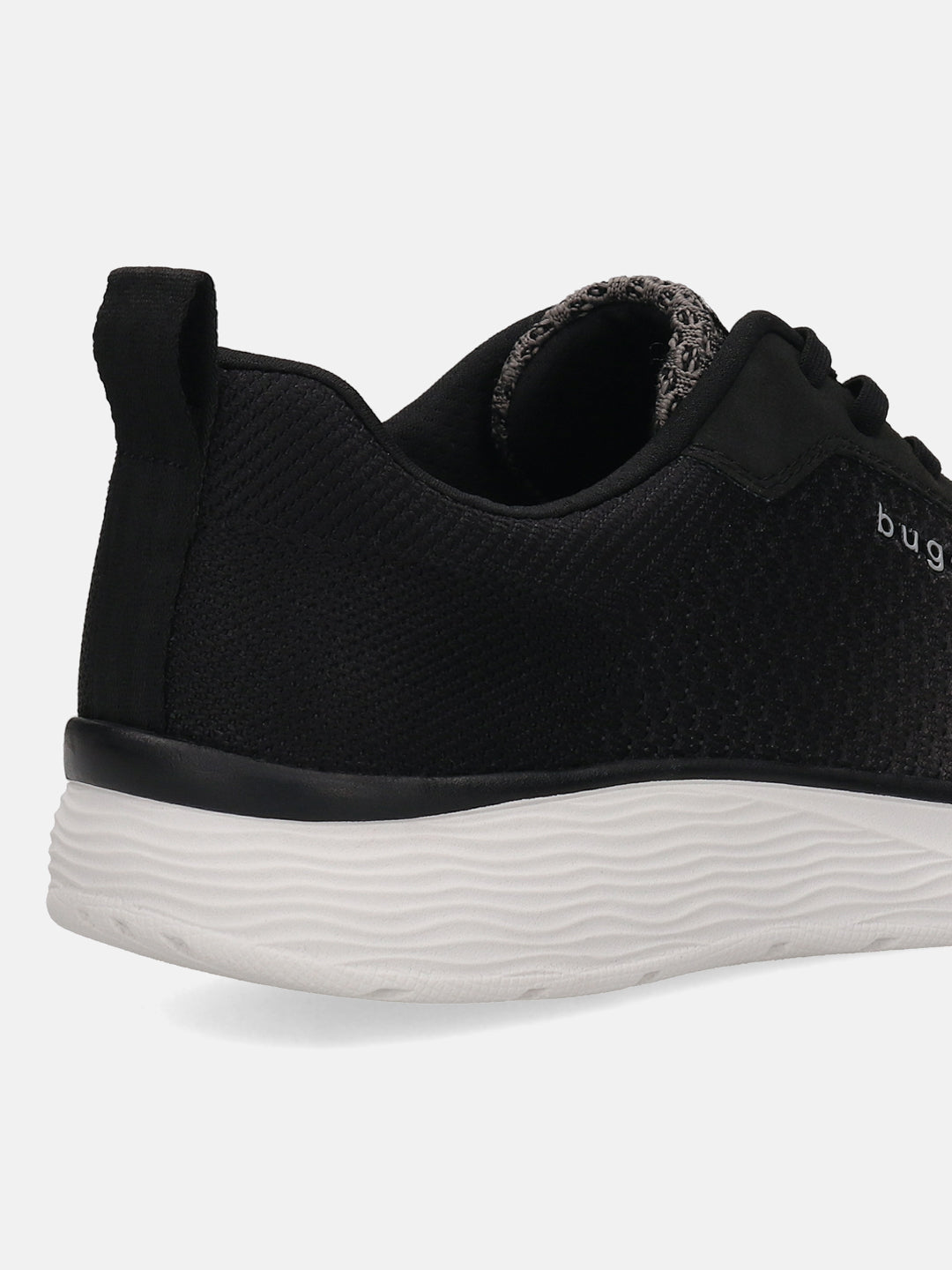 Cropped shot of a black bugatti Astra sneaker, showing the textured upper, heel tab, and wavy white sole.
