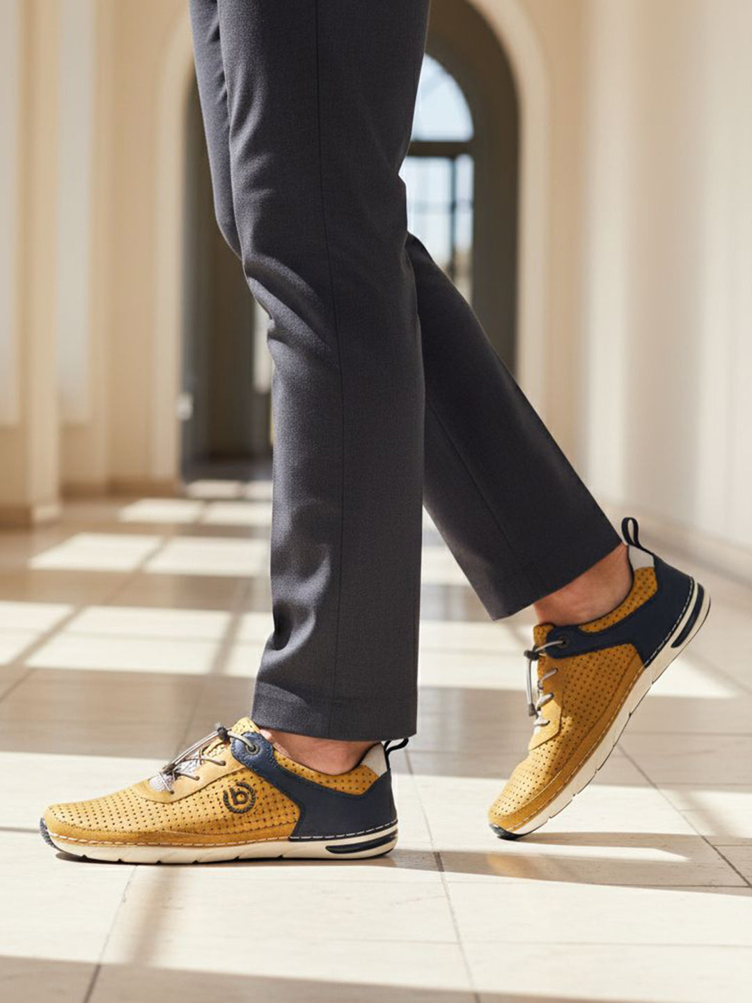 Lifestyle shot of bugatti Glenans yellow Comfort Sneakers featuring a perforated upper and navy accent.
