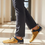 Lifestyle shot of bugatti Glenans yellow Comfort Sneakers featuring a perforated upper and navy accent.
