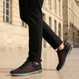 Lifestyle cropped shot of bugatti Glenans black comfort sneakers featuring a breathable upper, laces, and grey sole.
