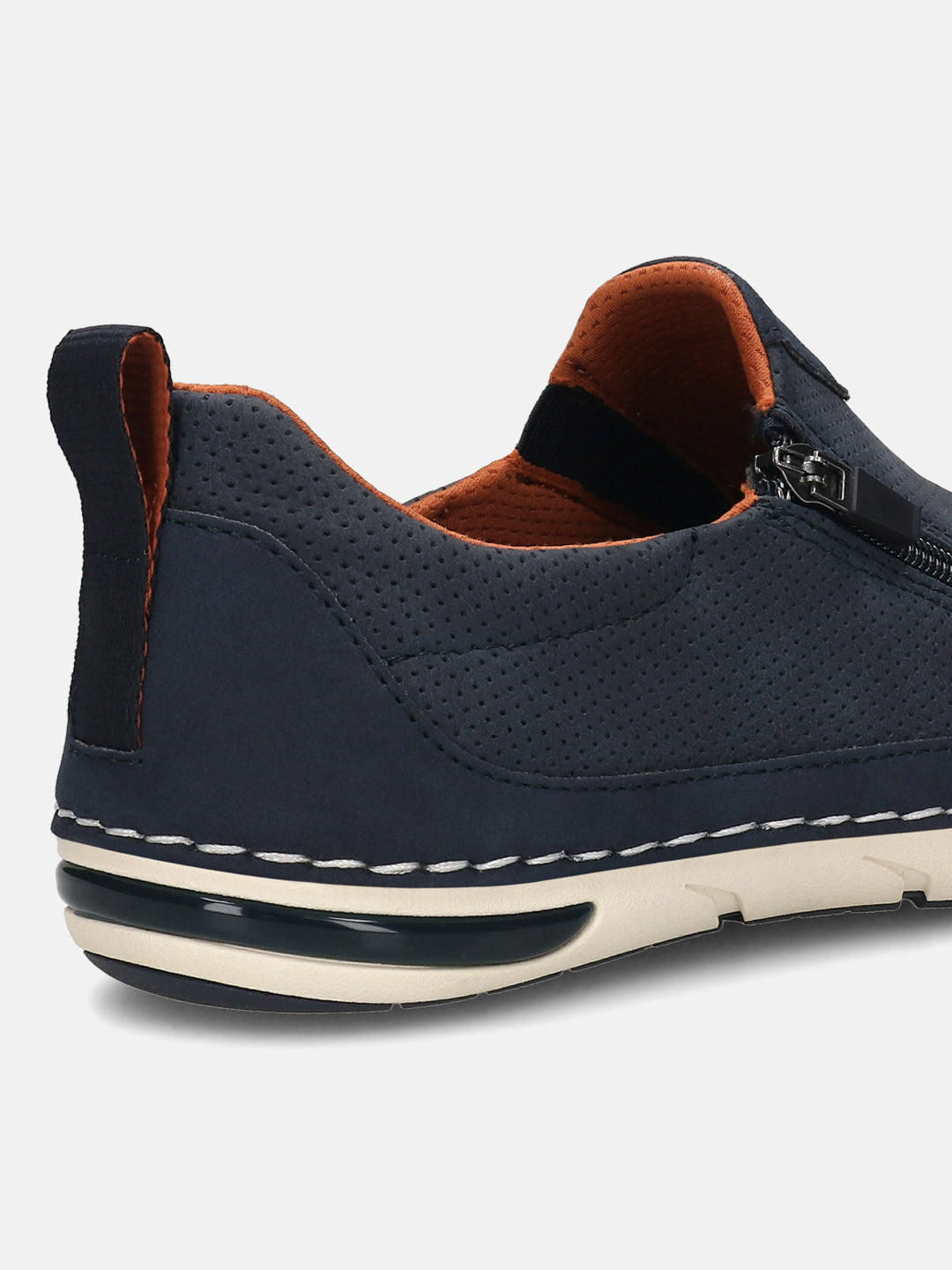 Back view of a dark blue bugatti slip-on shoe with perforated detail, tan lining, a zipper, and a heel pull tab.
