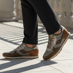 Lifestyle view of bugatti Sacramento brown comfort sneakers featuring a brown suede and gray textile design.
