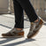 Lifestyle view of bugatti Sacramento brown comfort sneakers featuring a brown suede and gray textile design.
