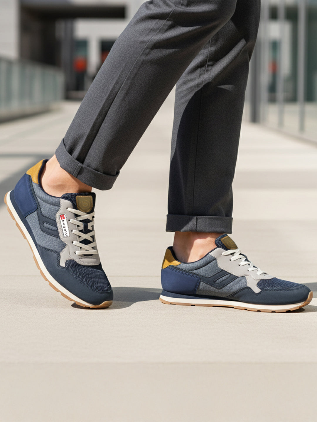 Lifestyle shot of bugatti Sacramento comfort sneakers in navy and gray with a tan accent.